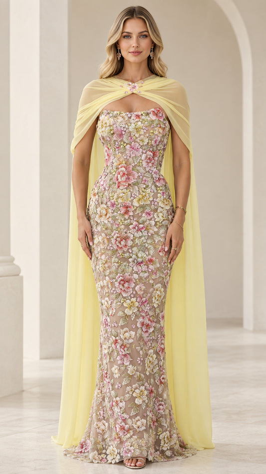 Pastel yellow floral embroidered strapless evening gown with sheer chiffon capelet front view