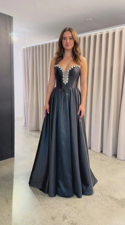 Front view of black strapless satin evening gown with crystal sweetheart neckline