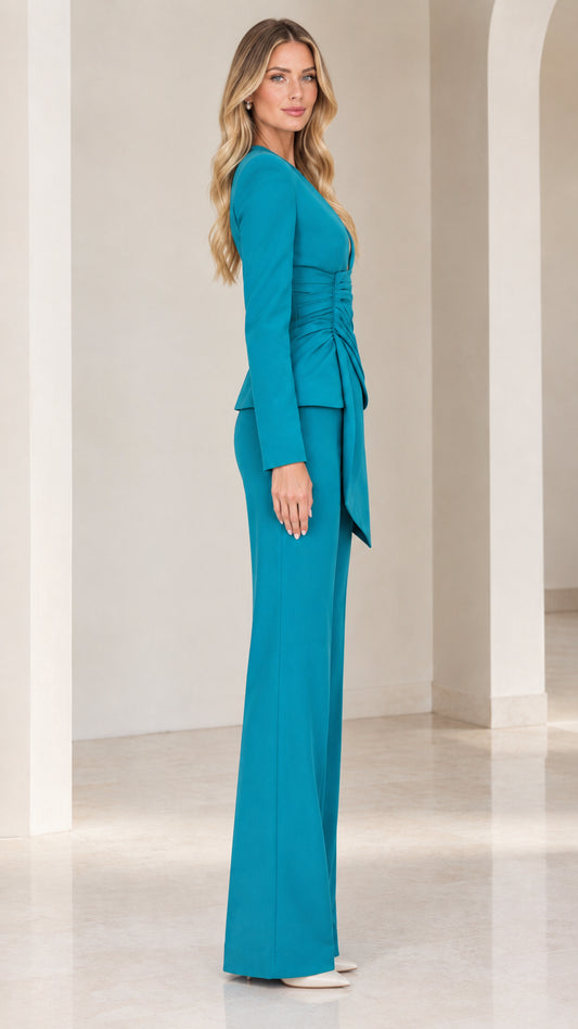 Side profile of woman wearing teal tailored two-piece pant suit set