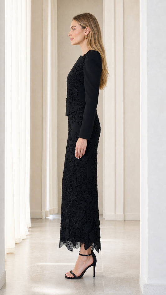 Side profile view of black long sleeve embroidered formal evening gown