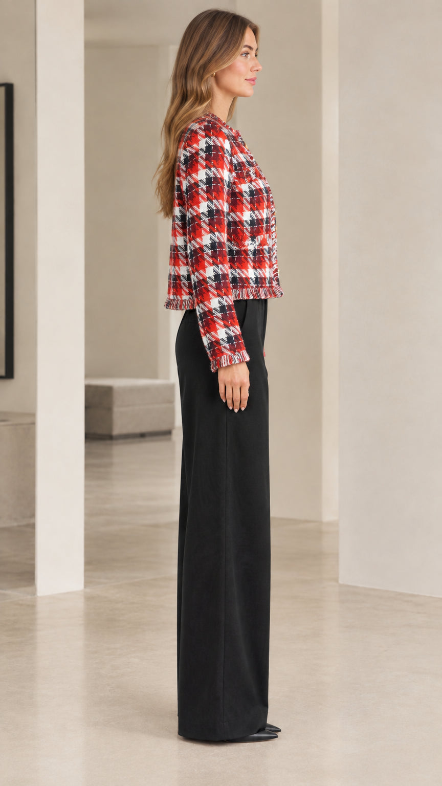 Side profile view of red plaid tweed jacket showing tailored sleeve and cropped hem