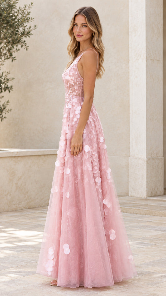 Side view of blush pink A-line tulle formal maxi dress with petal accents
