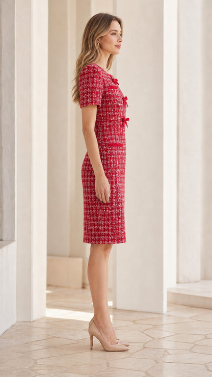 Side profile of woman in knee-length Red bow-accented tweed sheath dress