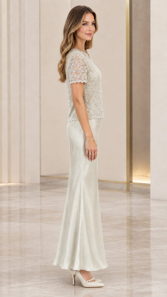 Side profile view of silver beaded bodice and flowing satin skirt evening dress