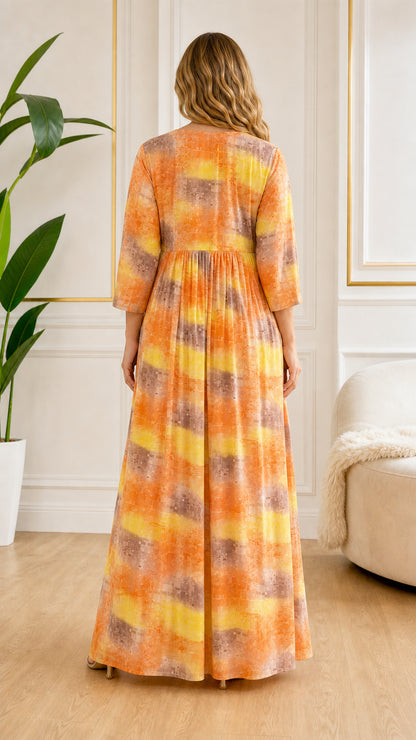 Back view of model showing full length drape of Orange abstract print maxi dress