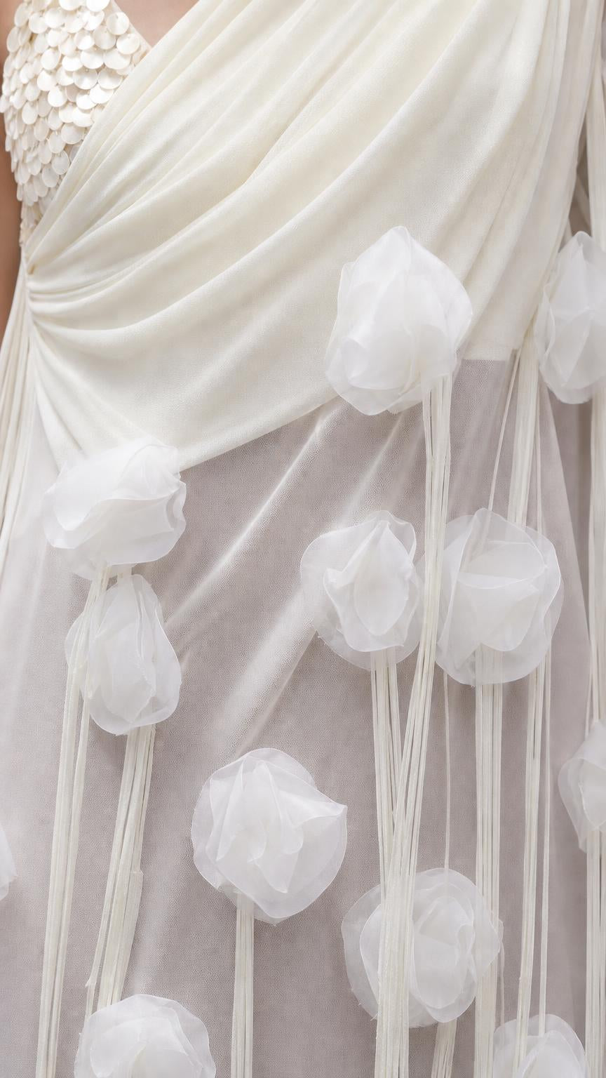 Close-up detail of sheer draped fabric and dimensional floral appliques