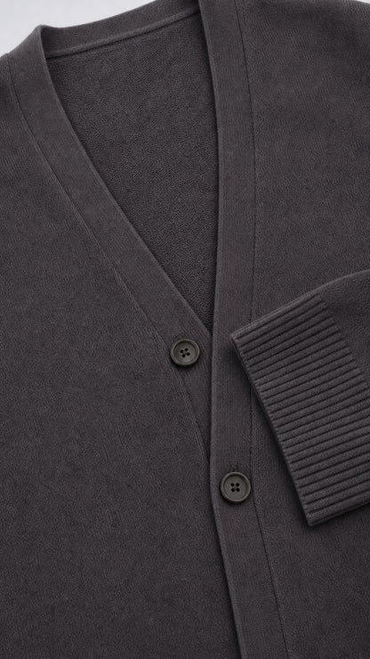 Close up view of Charcoal Grey cardigan showing V-neck, buttons, and ribbed cuff texture
