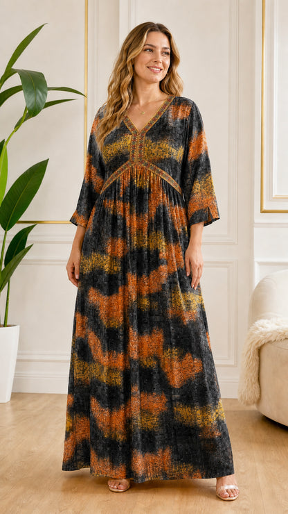 Front view of model wearing Black and orange abstract print empire waist maxi dress